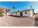 Spacious backyard offering a minimalist design with low maintenance landscape and bright blue skies at 4720 N 63Rd Ave, Phoenix, AZ 85033