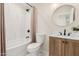 Modern bathroom featuring a new vanity, toilet, and tub/shower combo with tiled walls at 4720 N 63Rd Ave, Phoenix, AZ 85033