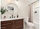 Modern bathroom with stylish vanity, round mirror and updated fixtures at 4720 N 63Rd Ave, Phoenix, AZ 85033