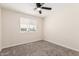 Bright bedroom with neutral walls, a ceiling fan, and a window at 4720 N 63Rd Ave, Phoenix, AZ 85033