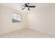 Bright bedroom with a large window and modern tile flooring for a clean and stylish look at 4720 N 63Rd Ave, Phoenix, AZ 85033