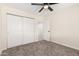 Cozy bedroom with a ceiling fan and a closet with sliding doors, providing ample storage at 4720 N 63Rd Ave, Phoenix, AZ 85033