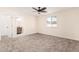 Bright, cozy bedroom with a ceiling fan and a view of an ensuite bathroom at 4720 N 63Rd Ave, Phoenix, AZ 85033