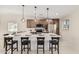 Bright kitchen featuring a large island with seating and modern pendant lighting at 4720 N 63Rd Ave, Phoenix, AZ 85033