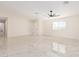 Bright living room featuring tile floors, ample natural light, and a modern ceiling fan at 4720 N 63Rd Ave, Phoenix, AZ 85033