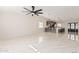 Open concept living room seamlessly connecting to the kitchen, featuring glossy tile floors at 4720 N 63Rd Ave, Phoenix, AZ 85033