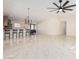 Bright living room featuring glossy tile floors seamlessly connecting to the kitchen and dining area at 4720 N 63Rd Ave, Phoenix, AZ 85033