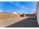 Low maintenance backyard featuring gravel, privacy wall and a storage shed at 5180 E Diatomite Dr, San Tan Valley, AZ 85143