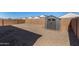 Well-maintained backyard with gravel, privacy wall and a storage shed at 5180 E Diatomite Dr, San Tan Valley, AZ 85143