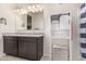 Bathroom with double sinks, granite counters, and a blue and white striped shower curtain at 5180 E Diatomite Dr, San Tan Valley, AZ 85143