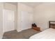 Bedroom with neutral carpet, a bed, and access to two separate closets at 5180 E Diatomite Dr, San Tan Valley, AZ 85143