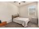 Bedroom with neutral carpet, a bed, a large window and a ceiling fan at 5180 E Diatomite Dr, San Tan Valley, AZ 85143