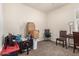 Empty bedroom features neutral carpet, a ceiling fan, and is staged as an office space at 5180 E Diatomite Dr, San Tan Valley, AZ 85143