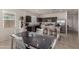 Well-lit kitchen adjacent to dining area, showcasing stainless steel appliances and dark brown cabinetry at 5180 E Diatomite Dr, San Tan Valley, AZ 85143