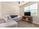 Living room features a large sectional couch, window and a vintage-inspired desk at 5180 E Diatomite Dr, San Tan Valley, AZ 85143