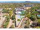 Stunning aerial view of a property showcasing a pool, tennis court and landscaped grounds in a desert setting at 5237 E Montgomery E Rd, Cave Creek, AZ 85331