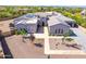 Aerial view of estate home featuring desert landscaping, tile roof, solar panels, and a circular driveway at 5237 E Montgomery Rd, Cave Creek, AZ 85331