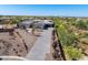 Aerial view of estate home featuring tile roof, solar panels, desert landscaping and long driveway at 5237 E Montgomery Rd, Cave Creek, AZ 85331