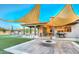 Backyard featuring shade sails, a modern fire pit, built-in grill, and lush artificial turf at 5237 E Montgomery E Rd, Cave Creek, AZ 85331