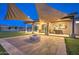 Backyard featuring shade sails, a fire pit, built-in grill, and lush artificial turf at 5237 E Montgomery Rd, Cave Creek, AZ 85331