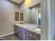 Bathroom with dual sinks, granite countertop, and a large mirror at 5237 E Montgomery Rd, Cave Creek, AZ 85331