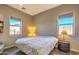 Bright bedroom with hardwood floors, a bed, and two windows that provide natural light at 5237 E Montgomery Rd, Cave Creek, AZ 85331