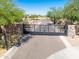 A private gate entry leads to this meticulously landscaped desert home with mature trees and desert flora at 5237 E Montgomery E Rd, Cave Creek, AZ 85331