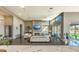 Bright and airy living room with a fireplace, modern furniture, and views of the lush outdoor space at 5237 E Montgomery E Rd, Cave Creek, AZ 85331