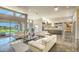 Expansive living room with modern sofas, tiled floors, and a clear view to the outdoor pool area at 5237 E Montgomery E Rd, Cave Creek, AZ 85331