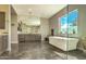 Stylish bathroom with a sleek soaking tub, expansive mirrors, and modern fixtures at 5237 E Montgomery E Rd, Cave Creek, AZ 85331