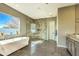 Bright bathroom with large tub, a seamless glass shower, and a large window, flooding the space with natural light at 5237 E Montgomery Rd, Cave Creek, AZ 85331