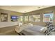 Inviting main bedroom featuring wood floors, a cozy sofa, and ample natural light from large windows at 5237 E Montgomery Rd, Cave Creek, AZ 85331