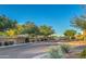 Street view of neighborhood entrance featuring mature desert landscaping and trees at 5237 E Montgomery Rd, Cave Creek, AZ 85331