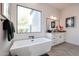 Modern bathroom featuring a freestanding tub, vanity, and a large window at 54Xx E El Sendero Dr, Cave Creek, AZ 85331