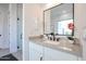 Bathroom vanity with a neutral countertop, white cabinetry and modern black hardware at 54Xx E El Sendero Dr, Cave Creek, AZ 85331