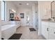 Elegant bathroom featuring a freestanding tub, white cabinets, and herringbone tile flooring at 54Xx E El Sendero Dr, Cave Creek, AZ 85331