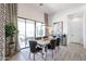 Bright dining room featuring a wooden table, black leather chairs, patterned drapes, and access to the outdoor patio at 54Xx E El Sendero Dr, Cave Creek, AZ 85331