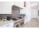 A modern kitchen features stainless steel appliances, dark backsplash, and custom white cabinetry at 54Xx E El Sendero Dr, Cave Creek, AZ 85331