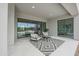 Covered patio featuring comfortable seating, a patterned rug, and sliding glass doors leading to the backyard at 54Xx E El Sendero Dr, Cave Creek, AZ 85331