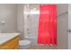 Bathroom featuring a single sink vanity and a shower with a red shower curtain at 6219 W Navajo Dr, Glendale, AZ 85302