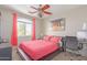 Bright bedroom with large window, stylish decor, and a comfortable workspace at 6219 W Navajo Dr, Glendale, AZ 85302