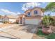 Inviting two-story home showcasing a well-maintained front yard, desert landscaping, and a spacious driveway at 6219 W Navajo Dr, Glendale, AZ 85302