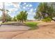 Scenic view of a grassy green space with mature trees and residential properties at 6219 W Navajo Dr, Glendale, AZ 85302