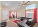 Comfortable living area featuring high ceilings, a ceiling fan, plush carpeting, and plenty of natural light at 6219 W Navajo Dr, Glendale, AZ 85302