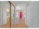 Hallway view to main bath with double sinks, walk-in shower and closet at 6219 W Navajo Dr, Glendale, AZ 85302