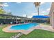 Backyard pool with covered patio, grassy area, and plenty of room for sunbathing at 6219 W Navajo Dr, Glendale, AZ 85302