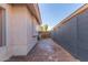 Paver pathway in side yard of home, framed by neutral wall and showing yard access at 6219 W Navajo Dr, Glendale, AZ 85302