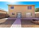 Backyard featuring patio area, double doors to the home, and a fire pit at 8626 W Las Palmaritas Dr, Peoria, AZ 85345