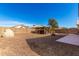 Backyard with pizza oven, pergola-covered outdoor kitchen and dining, and gravel ground at 8626 W Las Palmaritas Dr, Peoria, AZ 85345