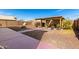 Spacious backyard with gravel, brick accents, a pergola and a unique pizza oven at 8626 W Las Palmaritas Dr, Peoria, AZ 85345